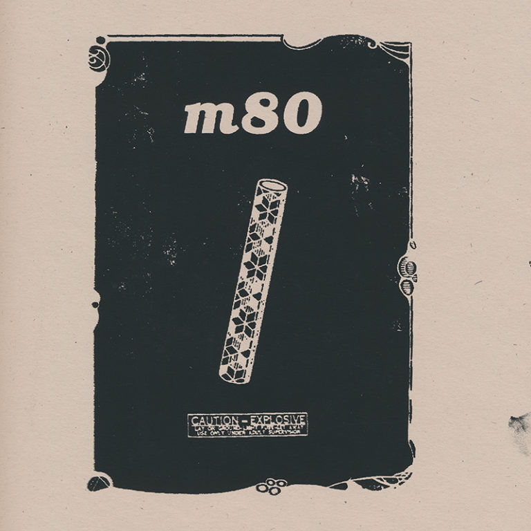 Front cover of m-80 no. 6 featuring a black print on card stock depicting a firecracker