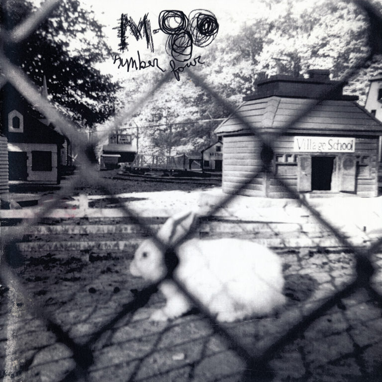 The cover of m-80 No. 4 featuring a black and white photo of a white rabbit behind a fence